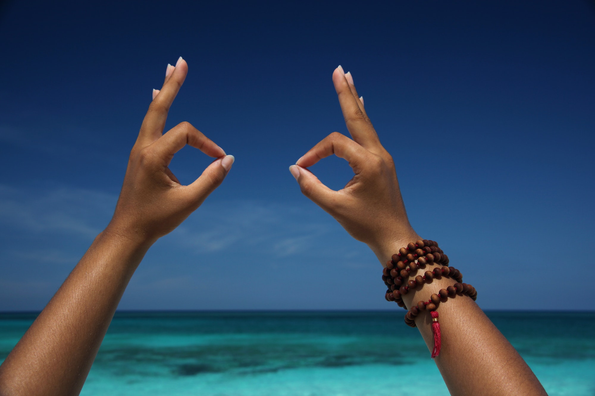 Best Spring Break Destinations for College Students - Close up of hands making gesture on beach, Paradise Island, Nassau, Bahamas